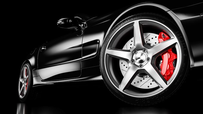 Close-up of a vehicle wheel with a red-painted brake caliper